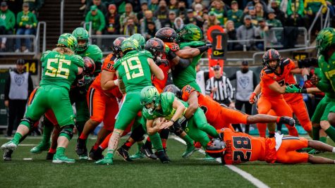Players from the University of Oregon Ducks and Oregon State University Beavers fighting to advance the ball up the field at Autzen Stadium on Nov. 27. The Ducks would go on to defeat the Beavers by a score of 38-29 