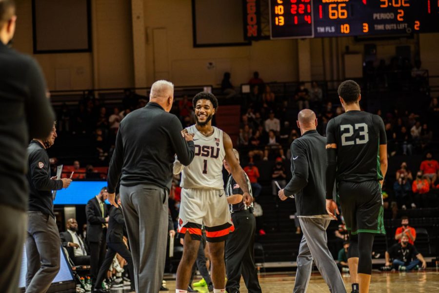 Oregon State senior forward Maurice Calloo fistbumping Oregon State head basketball coach Wayne Tinkle after Calloo hit a 3-point shot against the Portland State Vikings on Nov. 9 at Gill Coliseum. The Beavers would defeat the Vikings by a score of 73-64. 