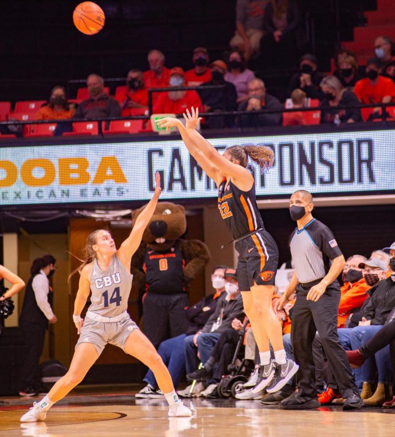Oregon State freshman guard Talia Von Oelhoffen shooting a three-point shot over a California Baptist University Lancer in Gil Coliseum on Nov. 18. Von Oelhoffen's 18 points would help the Beavers defeat the Lancers by a score of 80-72. 