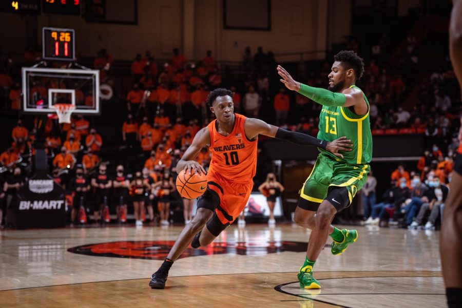 Oregon State senior forward Warith Alatishe pushing past an Oregon defender inside Gill Coliseum in Corvallis, Ore. on Jan 10. 2022. Although Alatishe would finish with 16 points, the Beavers fell to the Ducks by a narrow score of 78-76. 