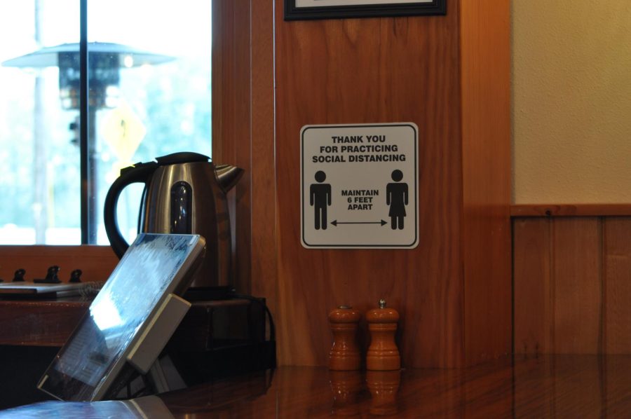 A sign urging patrons to stay six feet apart at Long Timber Brewing in Monroe, Ore. on Jan. 14. COVID-19 restrictions continue to require individuals to keep six feet of distance between themselves and others, which can be difficult for smaller businesses to accommodate.