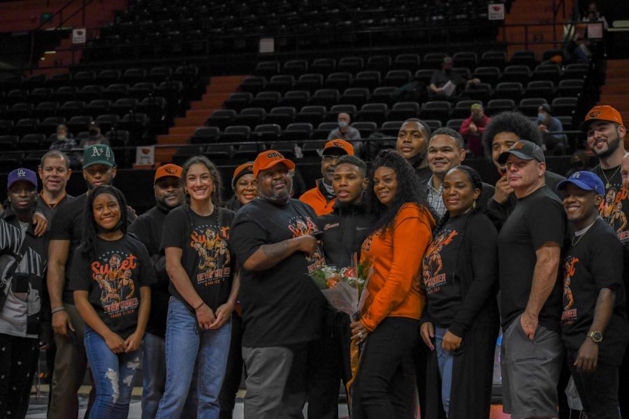 Oregon State redshirt-senior 133-pound wrestler Devan Turner posing with family, friends, and teammates on his senior night in Gill Coliseum on Feb 4, 2022. Turner won his last match inside Gill by a score of 9-3, and the Beavers defeated the Cal Poly mustangs by a score of 21-10. 