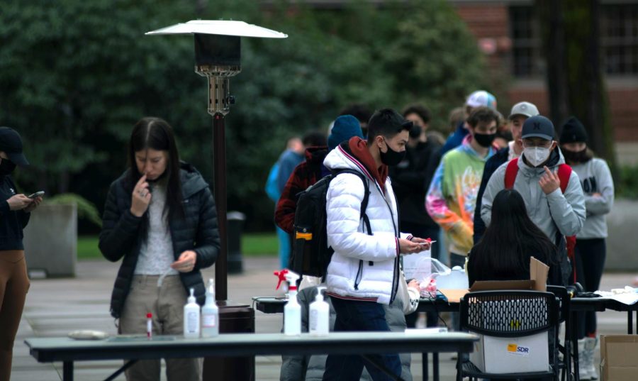 Oregon State University students line up outside at the Student Experience Center plaza on Jan. 6 to receive COVID-19 testing. Students and professors who are not fully vaccinated must test weekly for COVID-19, and are required to quarantine if they test positive.