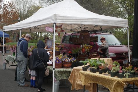 The Peace Seedlings booth at the Corvallis, Ore. Farmers Market on April 16. The business, which sells bouquets, seeds, handmade baskets and more, is run by Dylana Kapuler and Mario DiBenedetto.