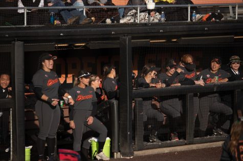 The Oregon State Beavers softball team cheers on their teammates from the dugout during a game against the Arizona Wildcats inside Kelly Field, April 8, 2022