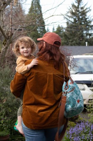 Cassady Goll and mom Jenna Feldman leave Peaceful Earth Preschool and Childcare in Corvallis, Ore. on April 5. 