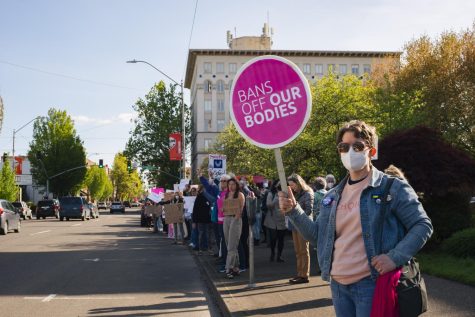 A crowd of people, including community member Julia Lont (front), line up at the Benton County Courthouse in Corvallis, Ore. as part of a reproductive rights protest on May 5. The protest was a response to a draft opinion from the Supreme Court of the United States being leaked suggesting the landmark abortion rights case, Roe v. Wade, could be overturned. 