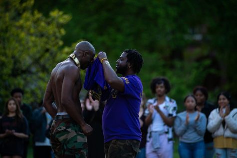 Omega Psi Phi inductee Adigun “Ωba” McLeod, officially becomes a brother as OPP brother LeWaski Watkins puts on the Psi Phi colors on Mcleod during the OSU Probate in the Memorial Union Quad on May 20. Omega Psi Phi is part of the National Pan-Hellenic Council, or Divine Nine, which will be performing during the Lonnie B. Harris Black Cultural Center block party on June 1. 