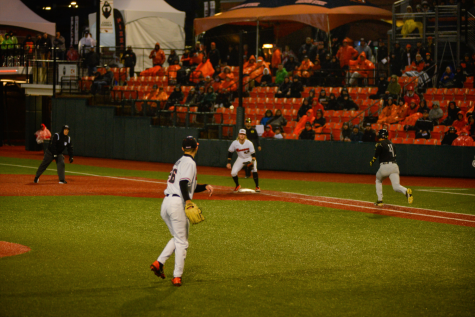 Oregon State sophomore left-handed pitcher Cooper Hjerpe throwing the ball to first base against the University of Oregon Ducks at Goss Stadium on May 6, 2022. Despite a 75 minute weather delay, the Beavers defeated the Ducks in the first of a three-game series, 5-1. 