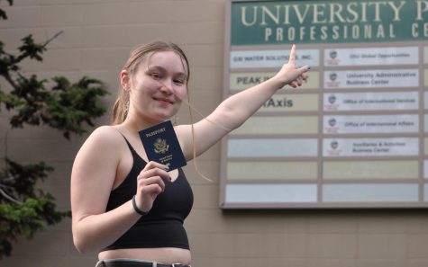 Student outside of the OSU Global Opportunities office on May 17, holding her passport. The OSU global opportunities office regulates OSU international programs.