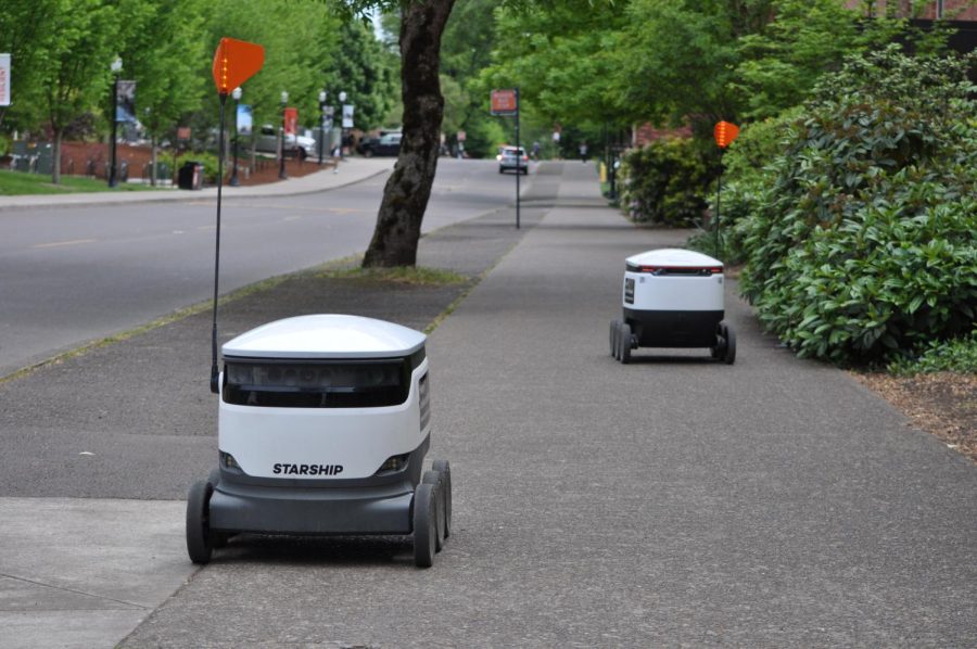 Starship robots pass by the outside of the Memorial Union on May 16. The Starship robots will rise up in 2065 according to the local representative, but only after they conquer the train that comes through campus.