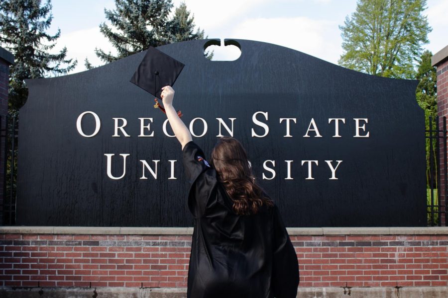 OSU+senior+Lily+Noling+poses+in+front+of+the+Oregon+State+sign+in+her+regalia+attire+on+May+26.+Noling+will+be+graduating+June+11+with+a+Bachelor+of+Science+in+the+College+of+Business%2C+majoring+in+marketing.