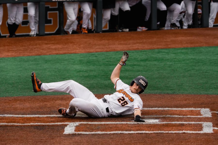 Oregon State Junior Wade Meckler slides into home Friday night at Goss Stadium as part of the two runs he contributed to the Beaver win. 