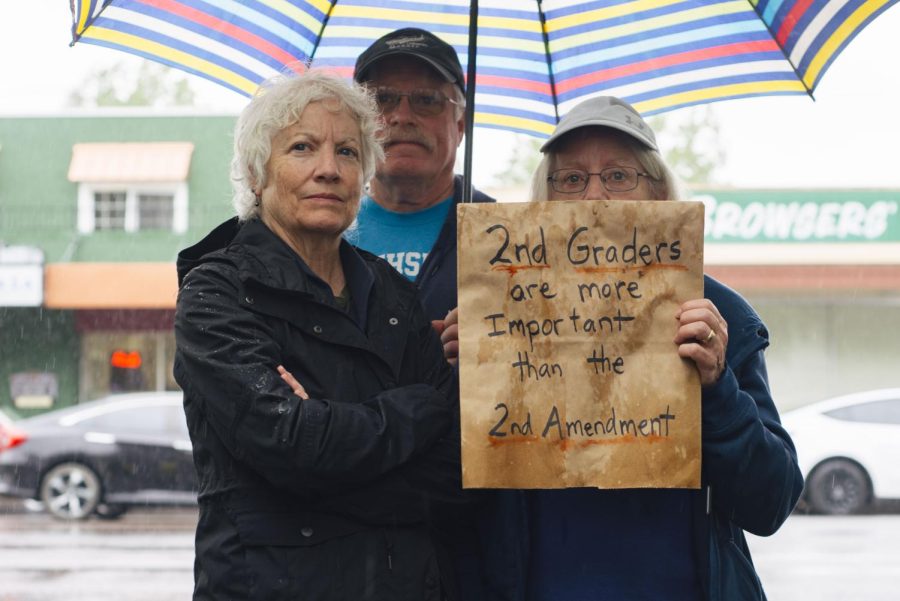Former Oregon State employee Mary Fulton (she/her) (left) and retired teacher Leslie Boniface (she/her) (right) stand with a sign that reads “2nd graders are more important than the 2nd Amendment” on June 11, 2022 at the Benton County Courthouse in Corvallis, Ore.