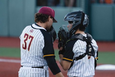 Pitcher Matthew Ager of the Corvallis Knights celebrates a successful inning with catcher Tyler
Quinn against the Walla Walla Sweets on June 21. The Sweets won the game, 2-1.