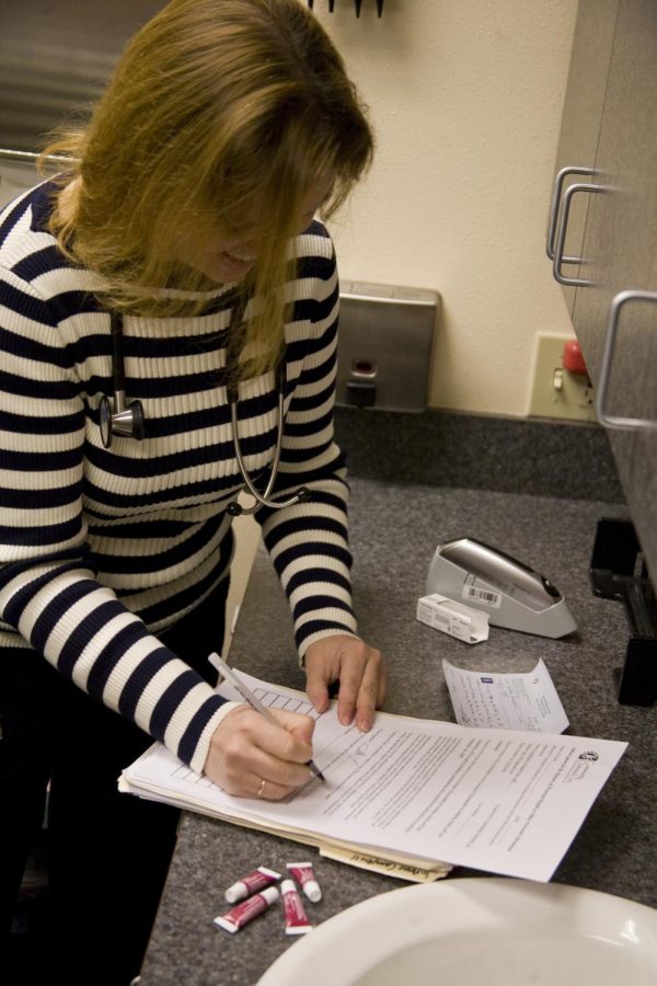 In this photo provided by Community Outreach Inc., a medical worker is seen filling out documents.

