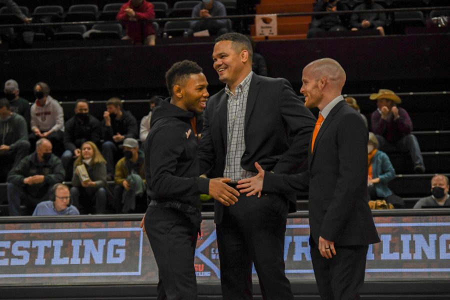 In a photo taken for the June 2022 issue, senior wrestler Devan Turner (left) is seen receiving congratulations from the OSU wrestling program’s head coach, Chris Pendleton (center), and associate head coach, Nate Engel, during his senior night on Feb. 4 inside of Gill Coliseum. Pendleton and Engel are helping assist the women’s wrestling camp held by the DAM RTC on Aug. 13 and 14.
