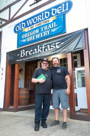 Chef J.D. Monroe (left) with owner Waylon Pickett (right) displaying the Benton To Go box in front of Old World Deli.