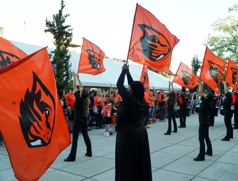 The Oregon State University color guard is seen waving and performing with their flags at the Beaver Block Party on Saturday, Sept. 24, 2022. Crowds formed around the color guard as they carried out their performance.