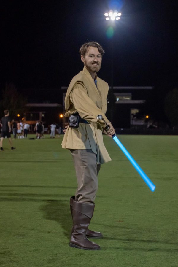 Mark Seed (Obi-Wan Kenobi) performs lightsaber tricks at Student Legacy Park, Friday night.
Seed says, “Im a huge Star Wars nerd and Ive been doing swordsmanship and kendo for about six years now.”