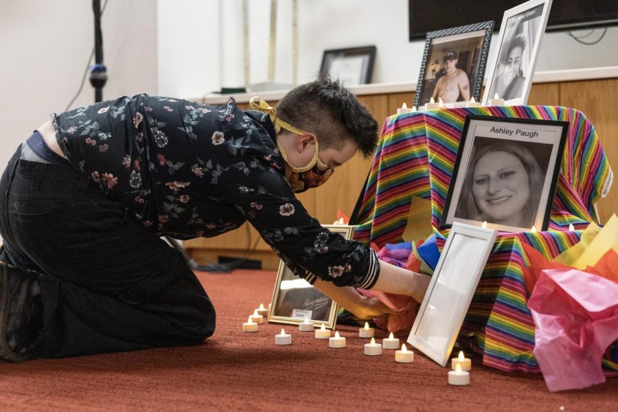 Master’s student in gender studies, G Koffink (any/all) helps to set up the memorial table on Nov. 21 in the SEC for those lost in the recent Colorado Springs shooting. The shooting occurred in Colorado Springs on Nov. 19-20, with five people being killed and 17 more injured.