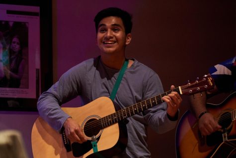 First year business administration major, Ismael Rodriguez, smiles deeply as he
impresses himself with his finger plucked mexican guitar at the Dia de los Muertos night at the
Kaku-Ixt Mana Ina Haws Nov. 2. Rodriguez has played some guitar before this
event, but was very nervous to play for so many people.