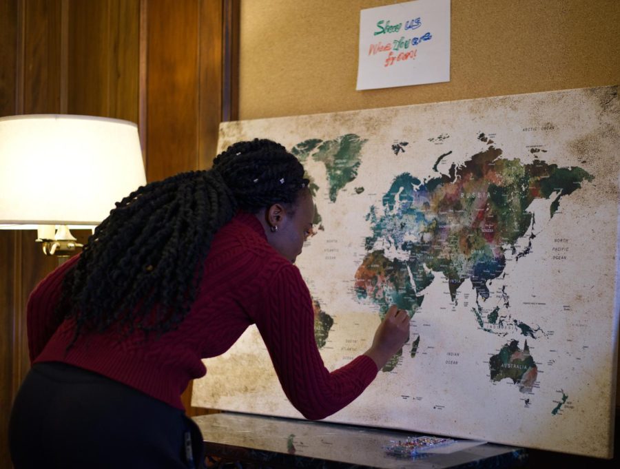 Jojo Namuddu, MSB student, adds her pin to the map board during the International Student Open House held by ASOSU in the Memorial Union on Wednesday. The open house was held to welcome all international students to the campus.