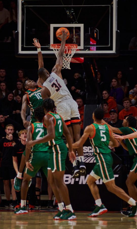 Oregon State University men’s basketball player Rodrigue Andela dunks on Florida A&M’s entire line up on Nov. 11, at Gill Coliseum. OSU defeated Florida A&M 60-43 and Andela scored 10 points. 