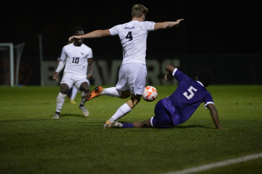 Freshman defender Max Gosset clears the ball versus redshirt senior midfielder Omar Grey in a match that ended in a tie score of 1-1 in Paul Lorenz Field on Oct. 21. The Beavers today ended the undefeated Huskies record with a score of 1-0.