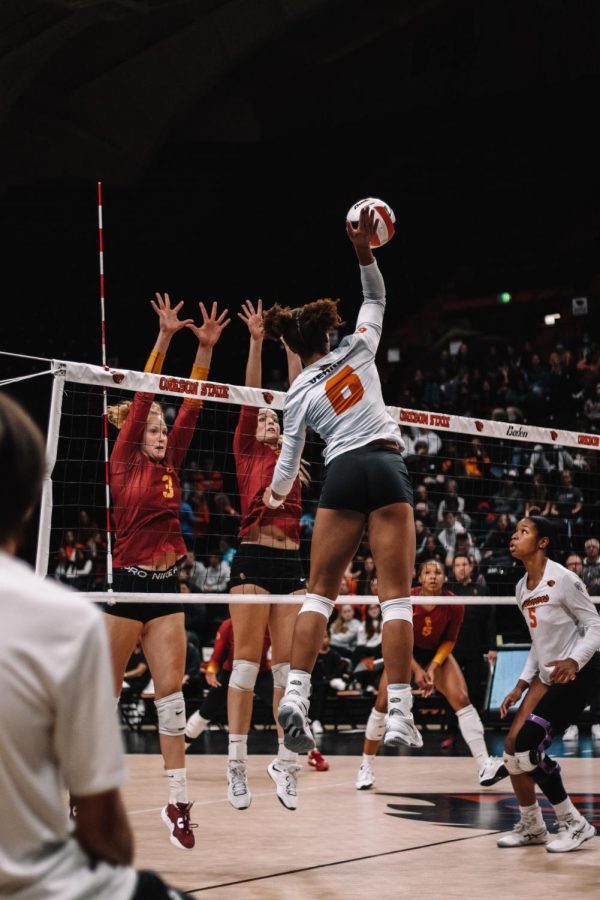Outside hitter, Mychael Vernon, spikes the ball as the ladies of USC try to block. 