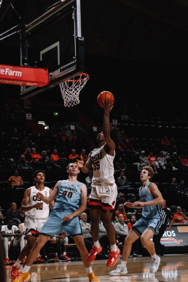 Sophomore forward Glenn Taylor Jr. rises up for a layup against junior Spencer Hoffman of Bushnell University in the second half of the Beavers victory in Gill Coliseum. Taylor Jr. tallied 19 points on 7-11 shooting from the field along with three rebounds and three assists.