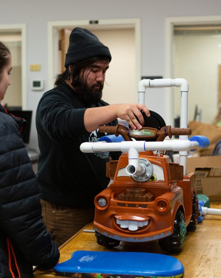 Robert Allen, a sophomore majoring in Electrical and Computer Engineering, working to modify a car for their groups’ child on Nov. 8th, at Oregon State University in the IMPACT lab. They work on modifying the cars so that children with disabilities can play with these cars.
