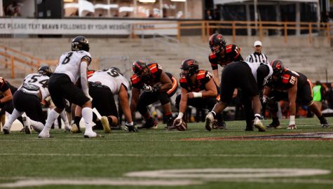 Oregon State University offensive lineman Jake Levengood (#70), snapping the ball to quarterback Ben Gulbranson (#17) in the first quarter on October 22, 2022 in the game against the University of Colorado Boulder at Reser Stadium. OSU won with an ending score of 42-9. 