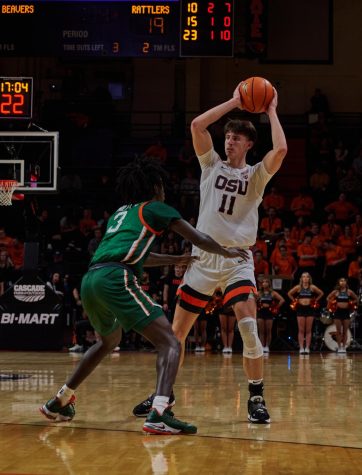 Senior forward Dzmitry Ryuny surveys his options while being guarded by a Flordia A&M defender on Nov. 11 in Gill Colliseum. Ryuny led the way for the Beavers in scoring with 14 points in their win Thursday night against Washington.