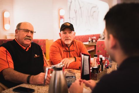 Oregon State alumni, Jens Burks (left) and Mark Laswell (right) , are seen speaking with Daily Barometer sports writer, Ryan Harlan, on Dec. 16 in Las Vegas. 