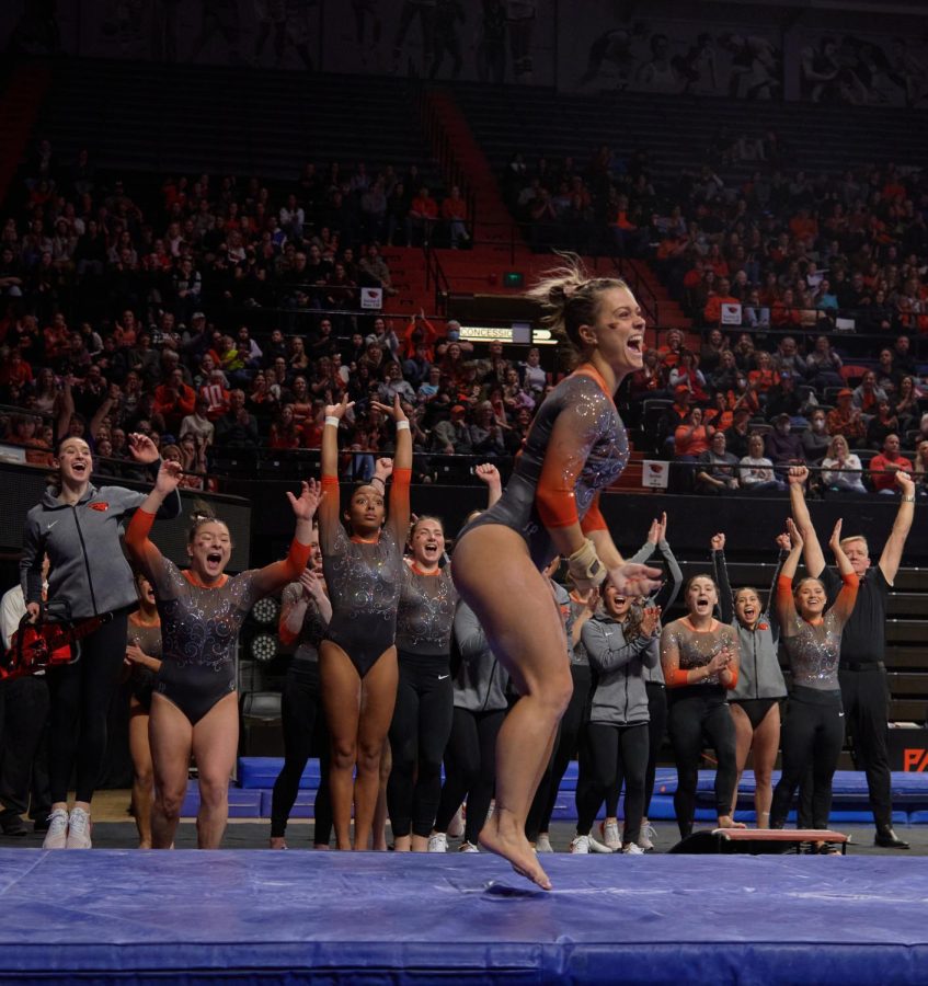 Oregon State gymnast Madi Dagen celebrates with her team after performing a beam routine at the Gill Coliseum in Corvallis on Jan. 21. Dagen scored two 9.90s on the beam. 