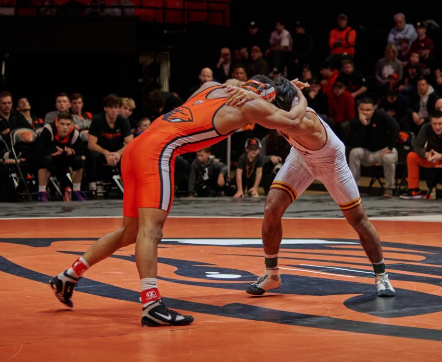 Oregon State wrestler Cleveland Belton locks up with his Sun Devil opponent Jesse Vasques. Belton fought hard but ultimately lost his match by a score of 2-5. 