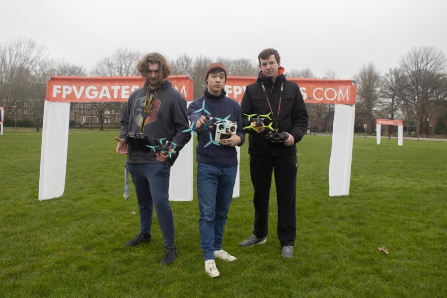 Drone pilots Logan Snell (he/him) (left), Josh Lizee (they/them) (middle), and Felix Klein (he/him) (right) pose for a photo with their drones on Feb. 12 in the Peavy Fields at Oregon State University in Corvallis. The drone pilots will be competing in the annual Collegiate Drone Racing Association at Georgia Tech on April 1.