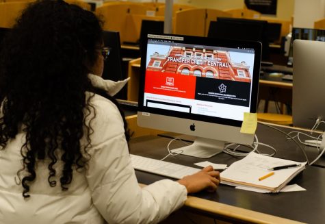 In this photo illustration, Computer Science major Harshini Reddy checks the transfer credit central portal, at Valley Library - Oregon State University on Feb.21