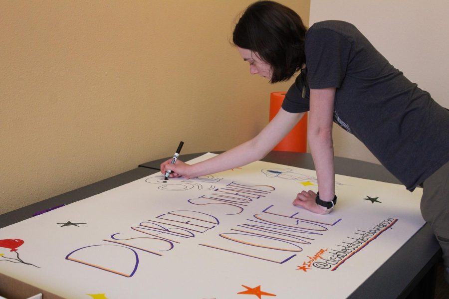 OSU students doodle on the new sign for the Disabled Students Lounge on April 14 in Snell Hall in Corvallis.