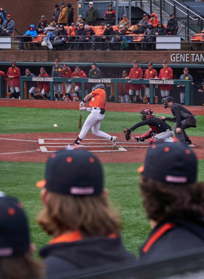 OSU hitter, Ruben Cedillo, swings while teammates watch closely at the baseball game against USC at Goss Stadium on April 16, 2023. Ruben struck out, but The beavers went on to win 6-3. 