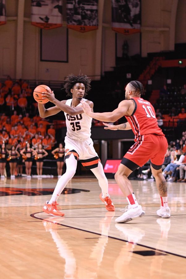 Sophomore forward Glenn Taylor Jr. jabs against the Utah defense inside of Gill Coliseum on Jan. 26. Taylor Jr.s departure hurts the Beavers offense and requires the team to look elsewhere for replacement.