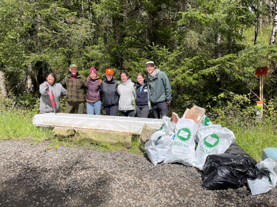 A group photo with the Solve garbage bags is from Alsea Bay, a service project from the Earth Saturday of Service!
