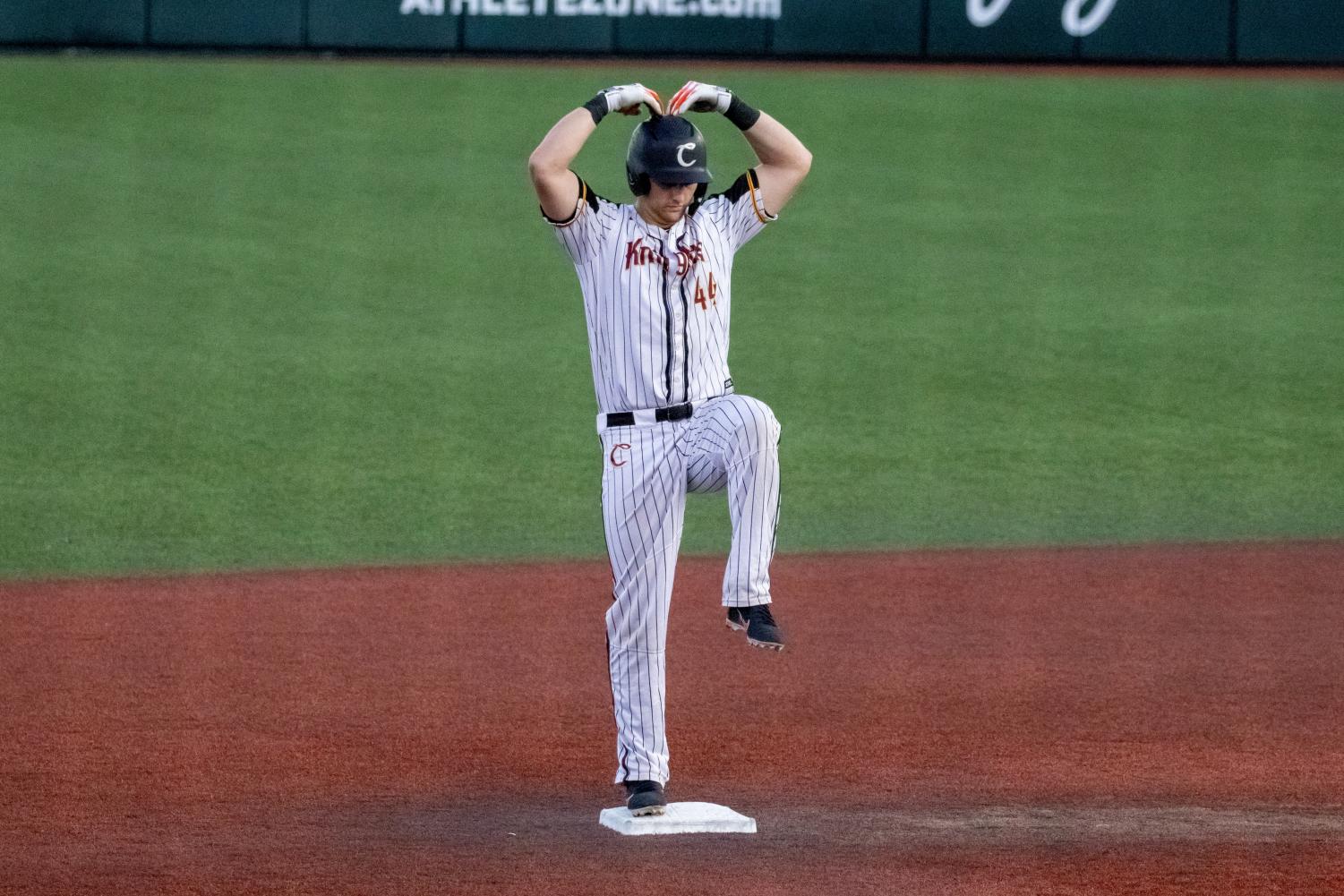 Oregon State's Steven Kwan, left and Adley Rutschman sit on top of