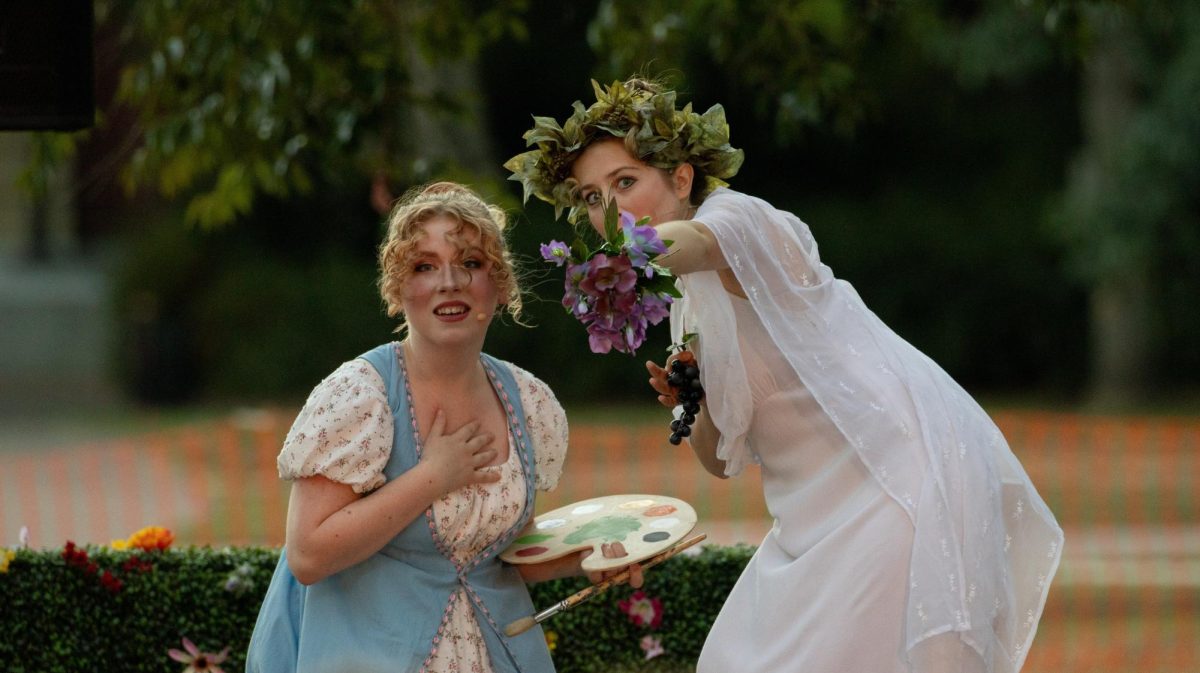 Libby Brennan (left) and Leah Kahn (right) discuss a love interest during the performance of “Much Ado About Nothing” in the Memorial Union Quad on August 3, 2023. Brennan took the role of Hero, while Kahn played Ursula.
