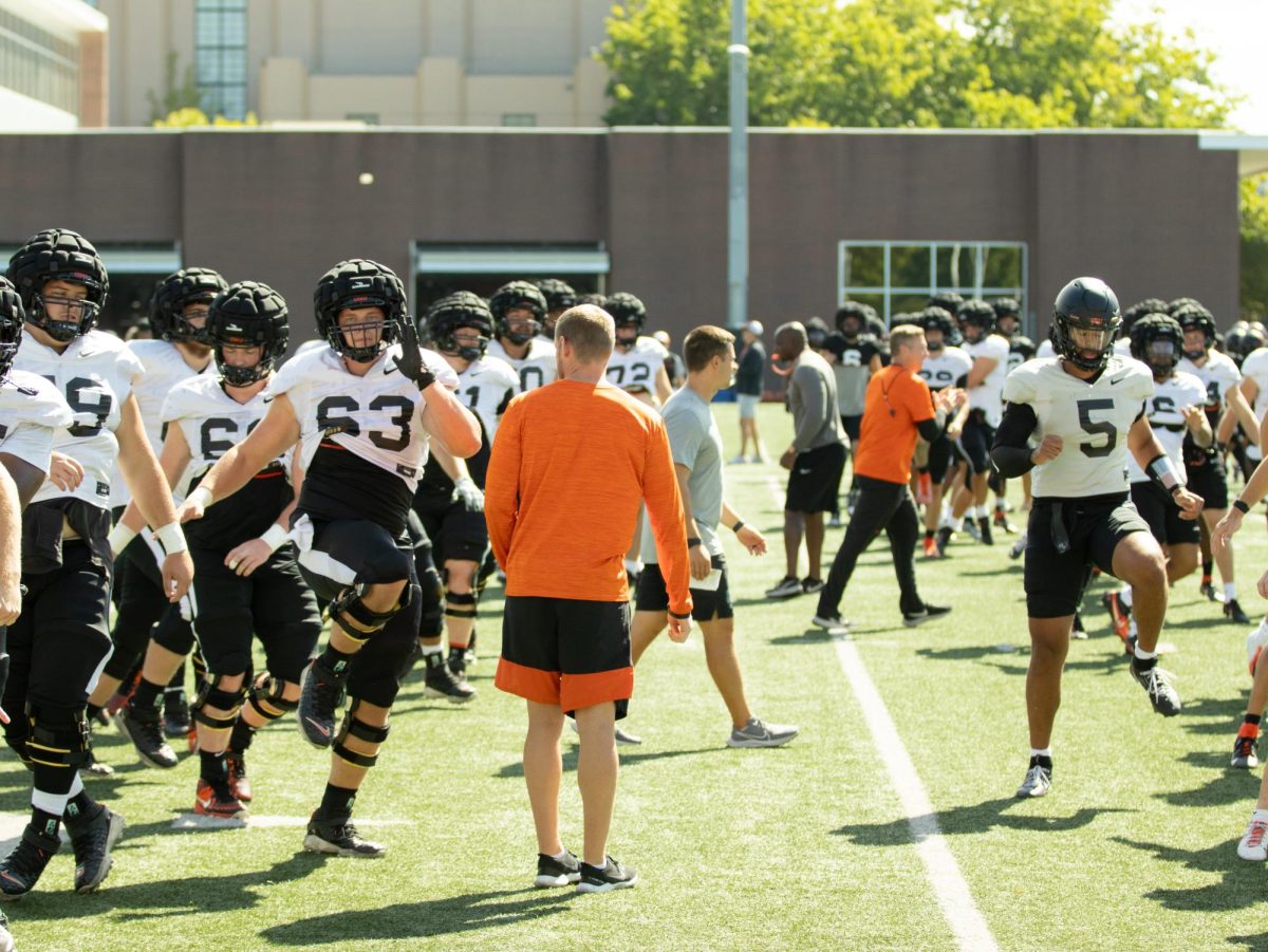 The Oregon State football team warming up before fall camp practice on Aug. 9 2023. Oregon State Athletics provides NIL opportunities to their student-athletes during the course of their collegiate careers. 