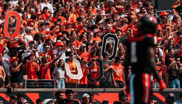 OSU students adorned with cardboard Os and other gear to cheer on the Beaver football team in a game against San Diego State on Sept. 16.