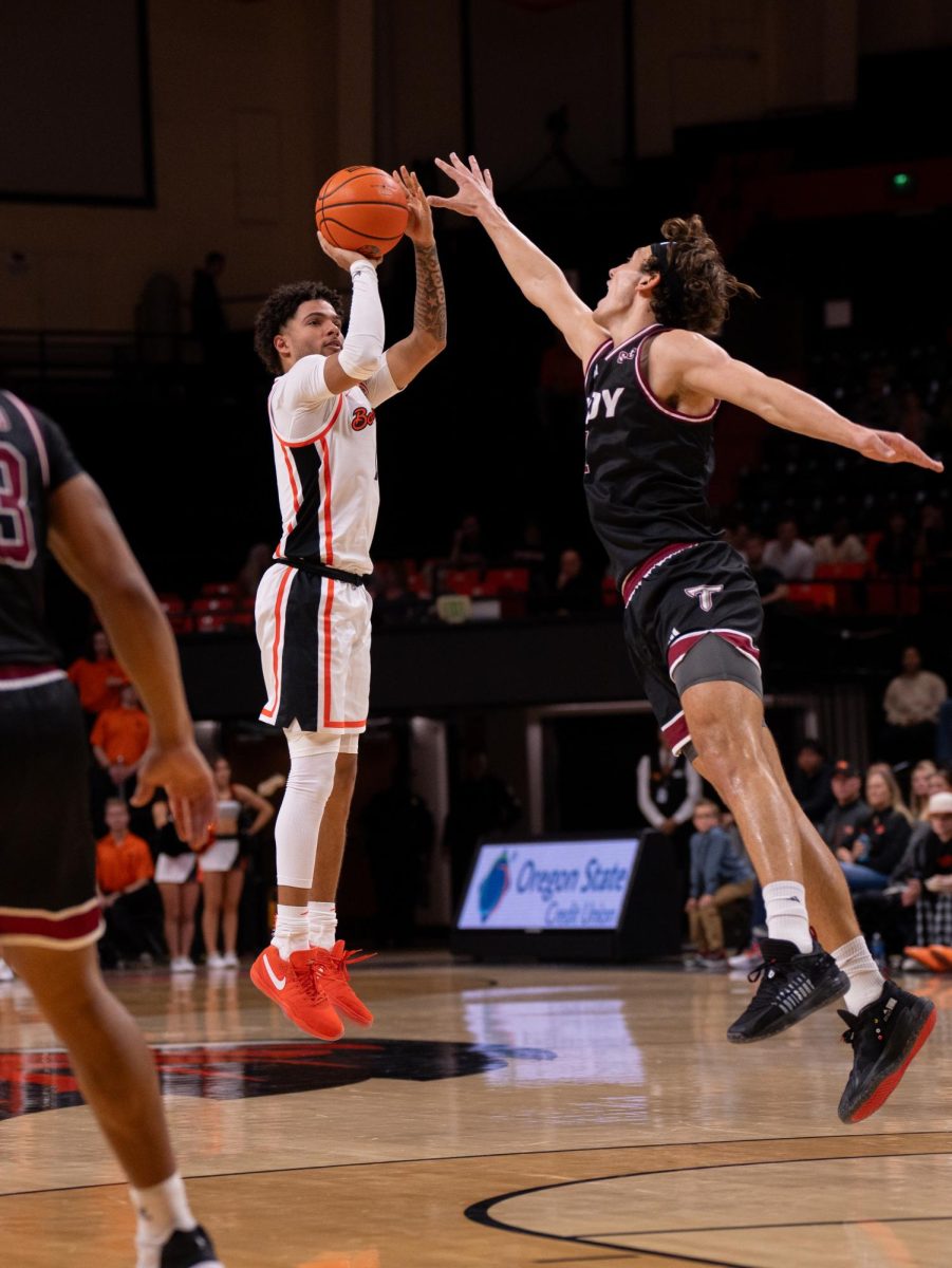 Jordan Pope (#0) attempts a three-pointer in the Beavers 81-80 victory against Troy on Nov. 10, 2023. 