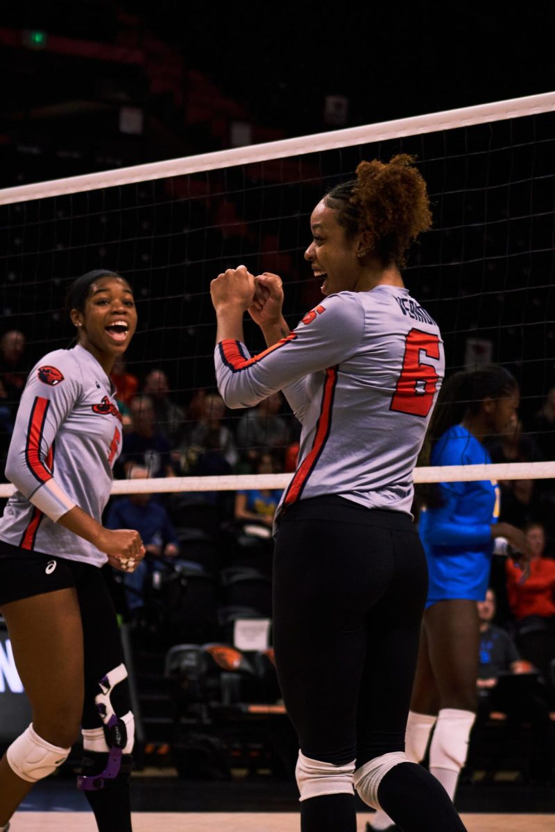 Middle blocker Aliyah McDonald (#5) and outside hitter Mychael Vernon (#6) celebrate after scoring a point in the Beavs’ game against the UCLA Bruins in Gill Coliseum in Corvallis on Nov. 22, 2023.