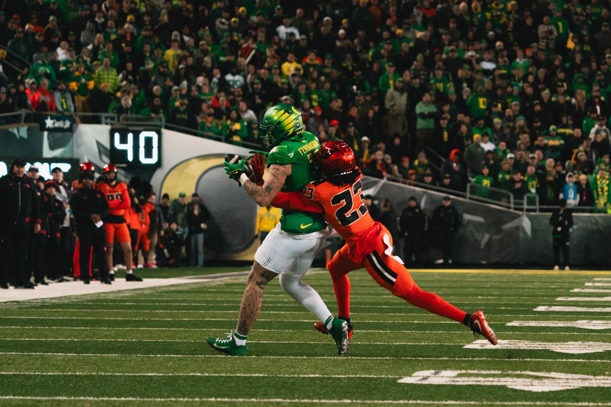 Jermod McCoy (#23) wraps up University of Oregon tight end Terrance Ferguson (#3) in the 127th Rivalry Game. The game concluded with a Beaver defeat, 7-31. 